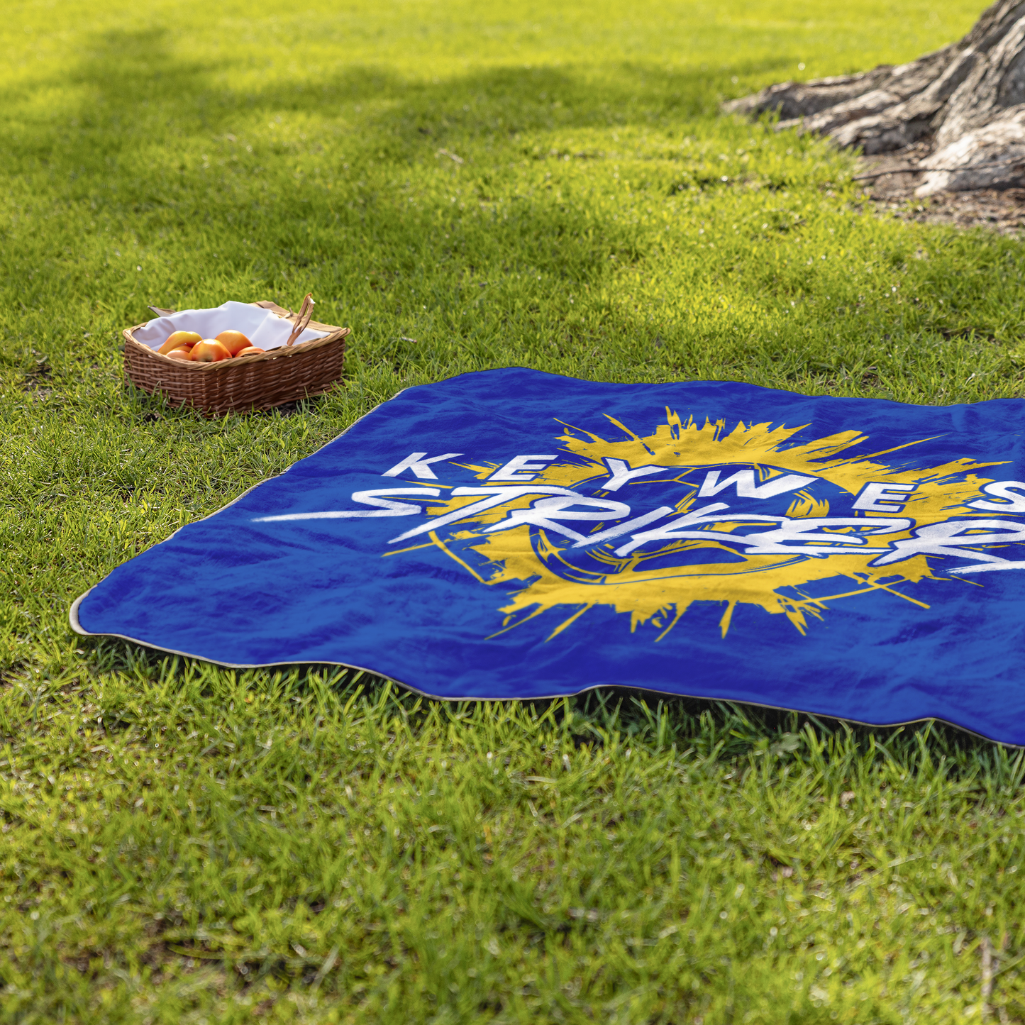 Key_West_Strikers_Stadium_Blanket_StadiumBlanket_Lifestyle_Grass_H_Mockup.png
